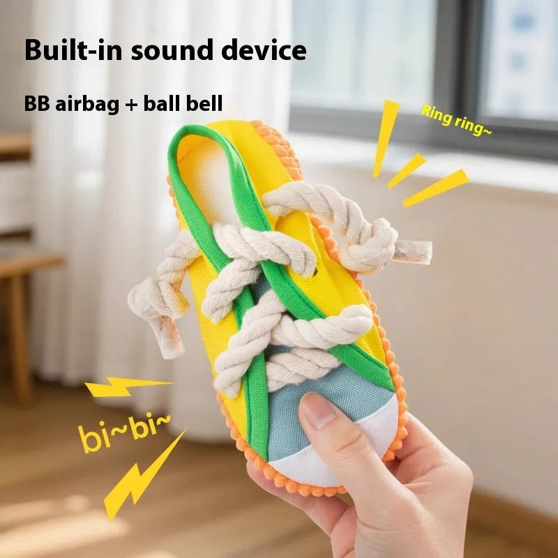 Plastic dog chew toy in slipper shape with sound feature, shown in yellow, black, and blue colour options.