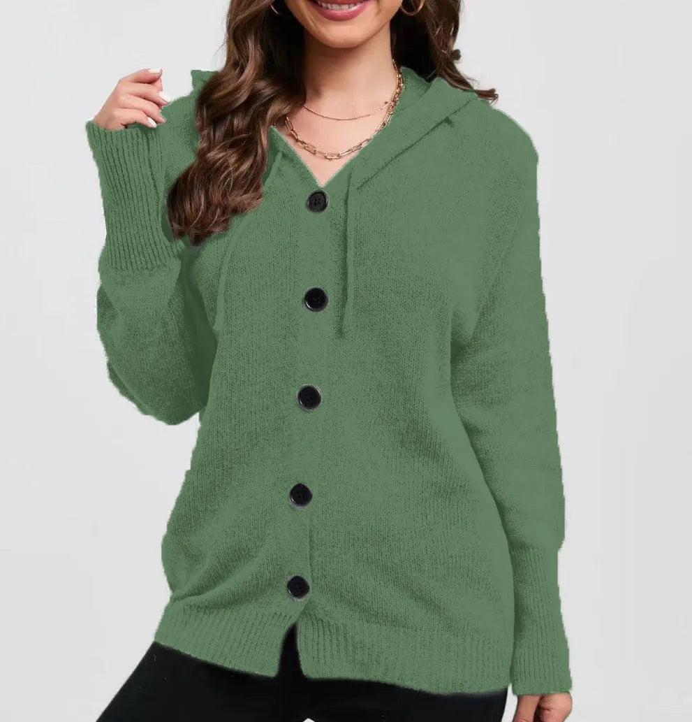 A woman wearing a loose-fit, solid-colour hooded cotton cardigan sweater.