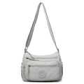 Water-repellent nylon crossbody bag with three-dimensional pocket in black, grey or red