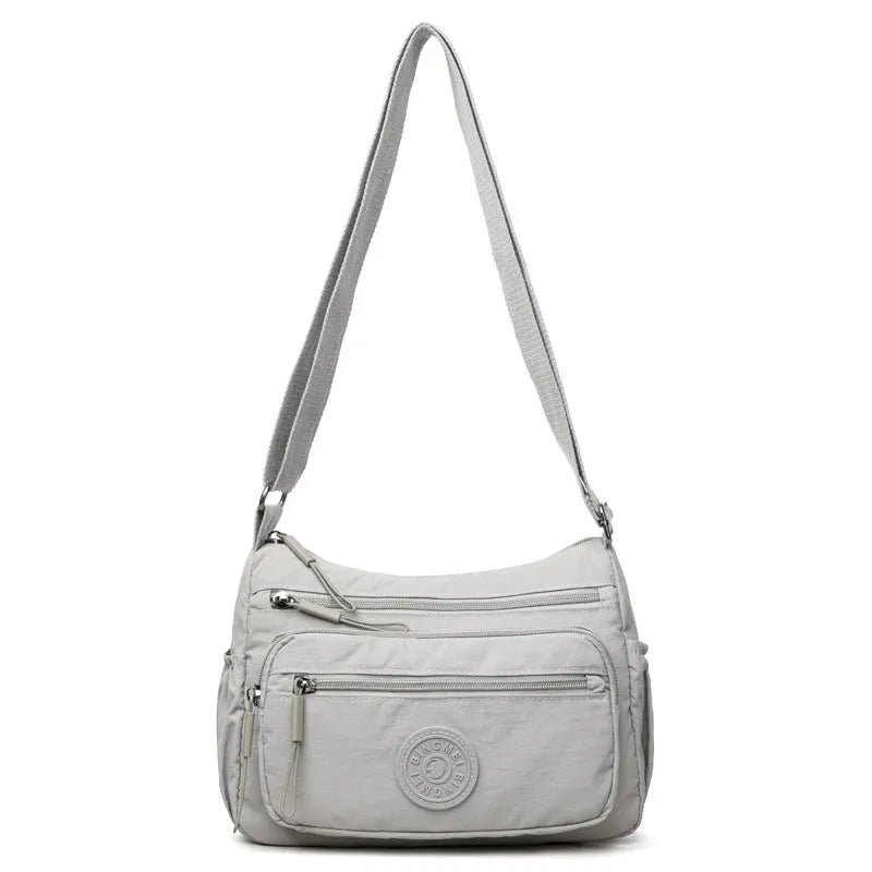 Water-repellent nylon crossbody bag with three-dimensional pocket in black, grey or red
