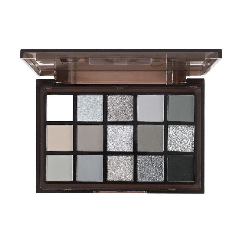 15-colour eyeshadow palette with matte and shimmer pans in grey, black, brown, and blue shades.