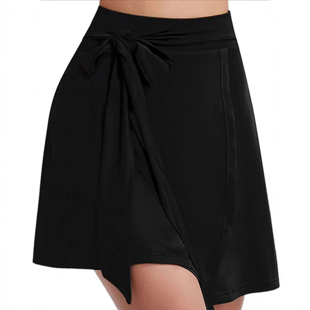 Black thigh-length unisex sports skirt with high waist and integrated shorts.