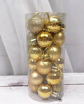 Assortment of shiny matte red, gold, and silver 3cm Christmas baubles spilling from a decorative barrel.