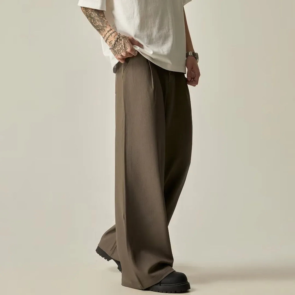 Men's solid colour wide-leg casual trousers in black, showing elastic waist and straight leg cut.
