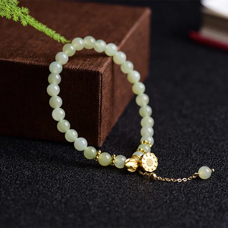 Natural Hetian Jade bracelet with Fu character detail on 6mm beads in a sunny water colour.