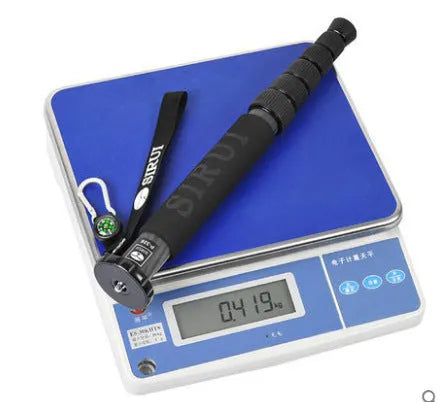 Black carbon fibre SLR camera monopod with telescoping legs extended.