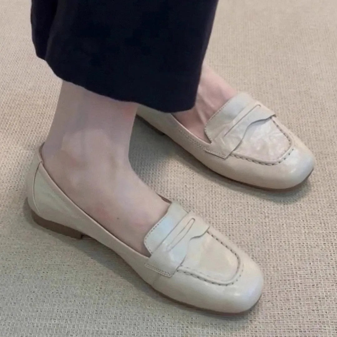 Beige white women's square toe flat shoes with cowhide upper and low heel on a plain background