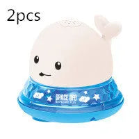 Whale-shaped electric bath toy spraying water with flashing lights, floating in baby bathtub