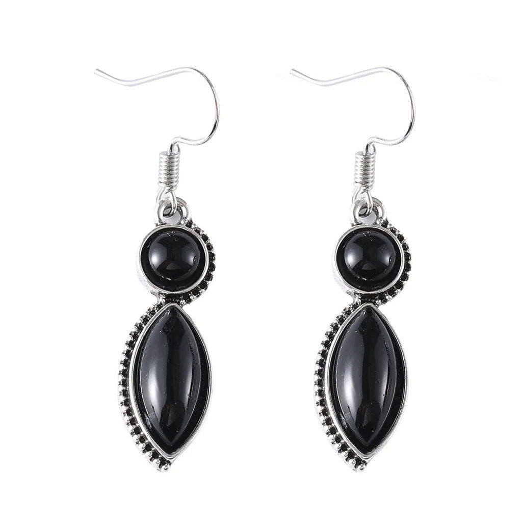 A pair of vintage geometric drop earrings with a round gemstone, in black and purple electroplated zinc alloy.