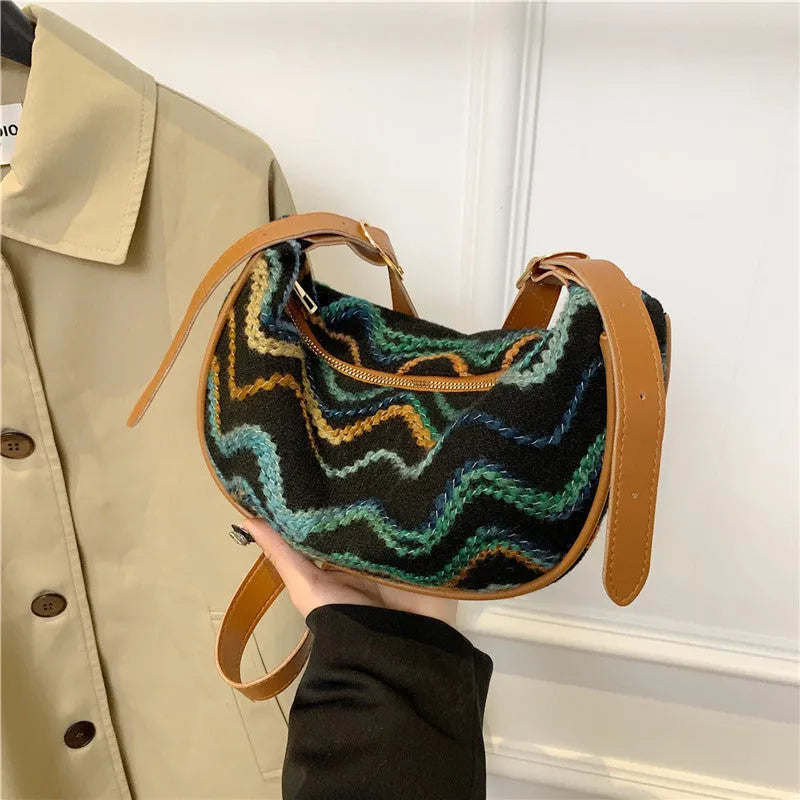 Women's straw woven crossbody bag showing woven texture and adjustable strap with internal phone and document pockets