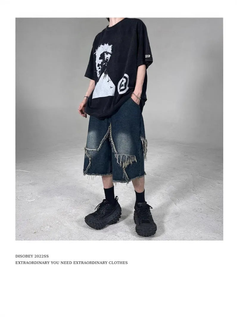 Blue men's loose-fit denim shorts with a frayed five-pointed star design on the leg.