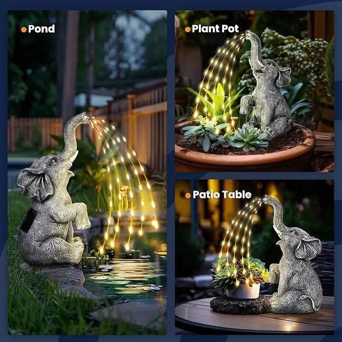 Resin elephant garden statue with built-in LED light strip on grass.