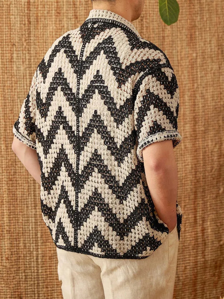 Beach knitted short-sleeved cardigan in black with lapel collar and loose fit on a woman