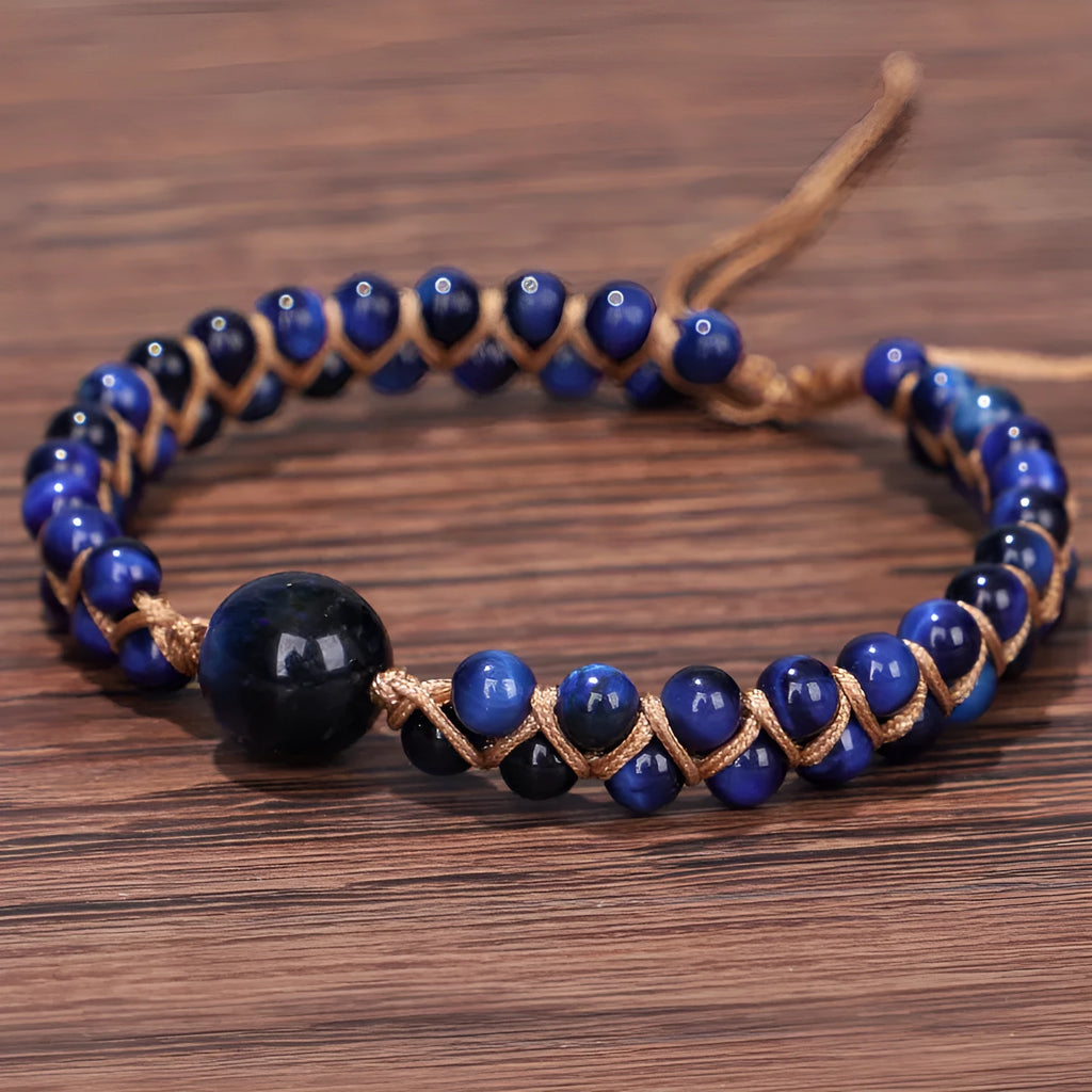 Handwoven geometric bracelet made from blue Tigereye stone beads with a slip-on closure.