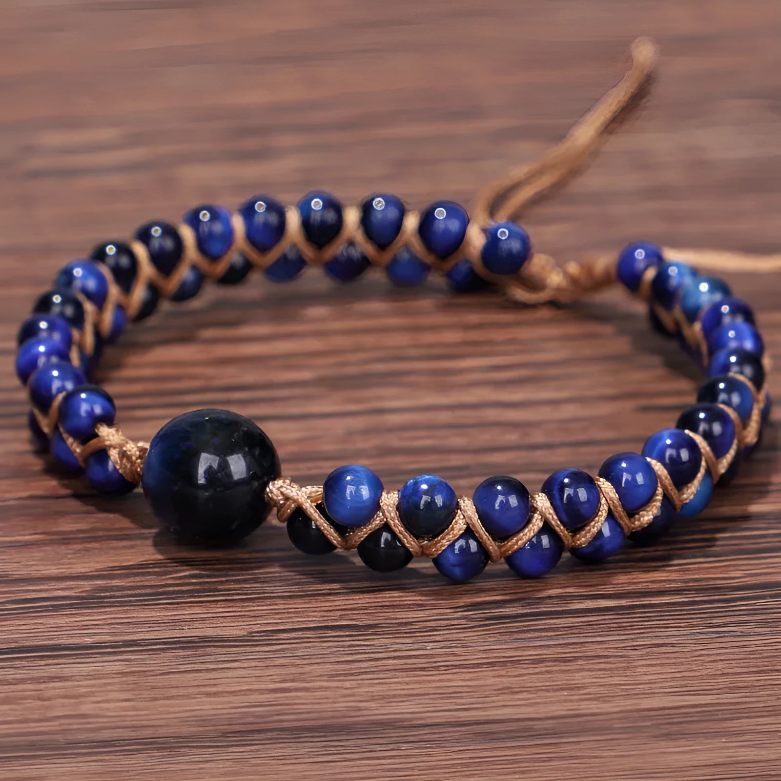 Handwoven geometric bracelet made from blue Tigereye stone beads with a slip-on closure.