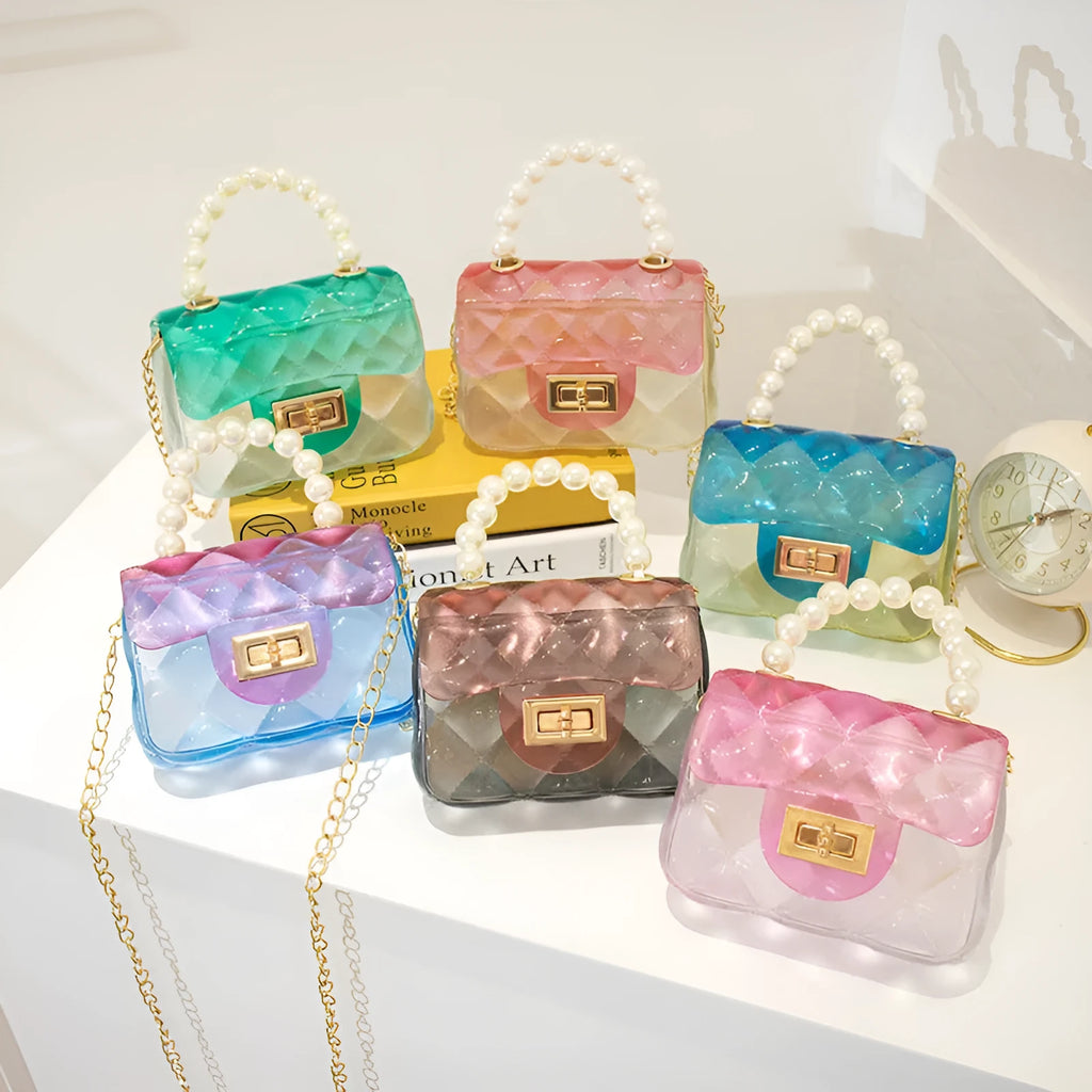 Mini kids crossbody bag in soft PVC with horizontal square shape, available in six colours including yellow, green, blue, black, and pink.