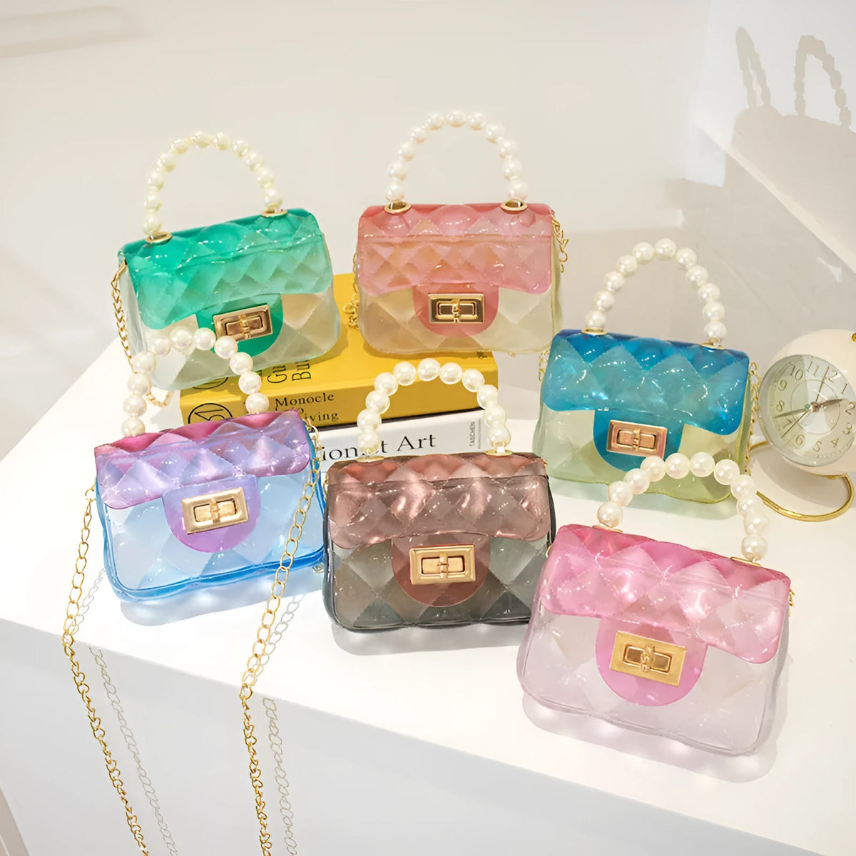Mini kids crossbody bag in soft PVC with horizontal square shape, available in six colours including yellow, green, blue, black, and pink.
