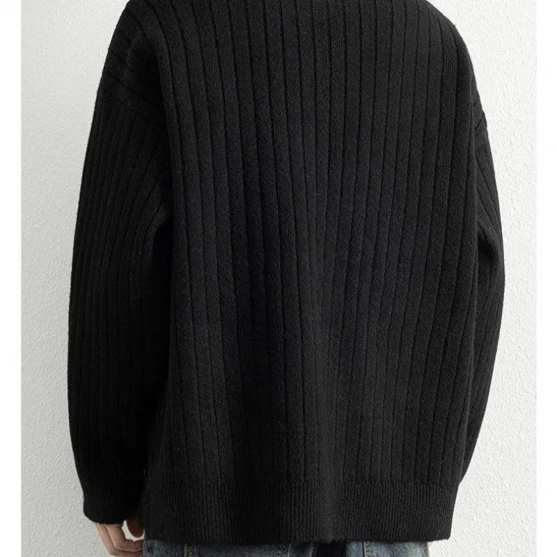 A grey men's half-zip texture knit sweater with a loose fit and long sleeves on a hanger.