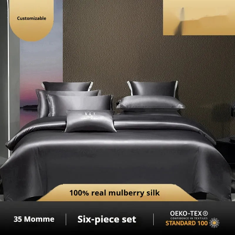 Silk four-piece quilt cover set in a solid light luxury colour, shown on a bed.