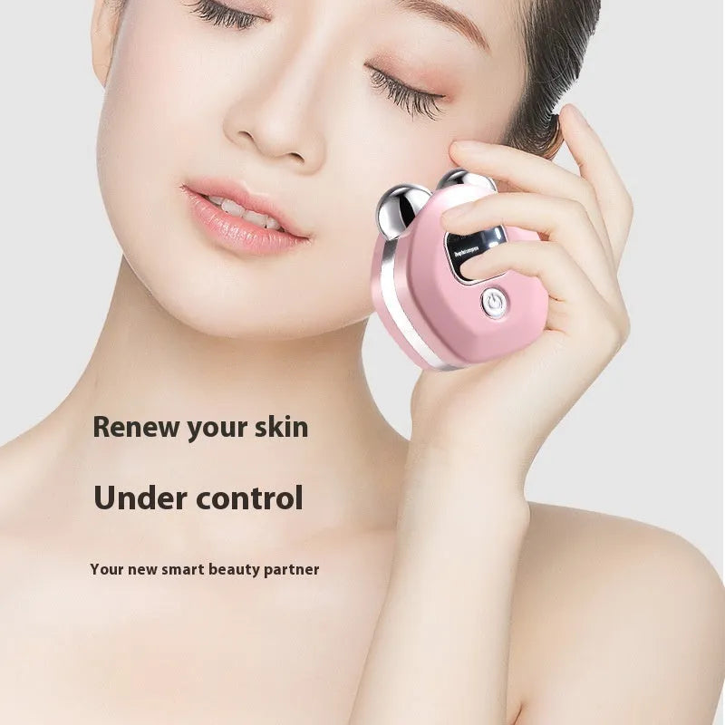 Portable white facial massage instrument with double-roller head and charging cable.