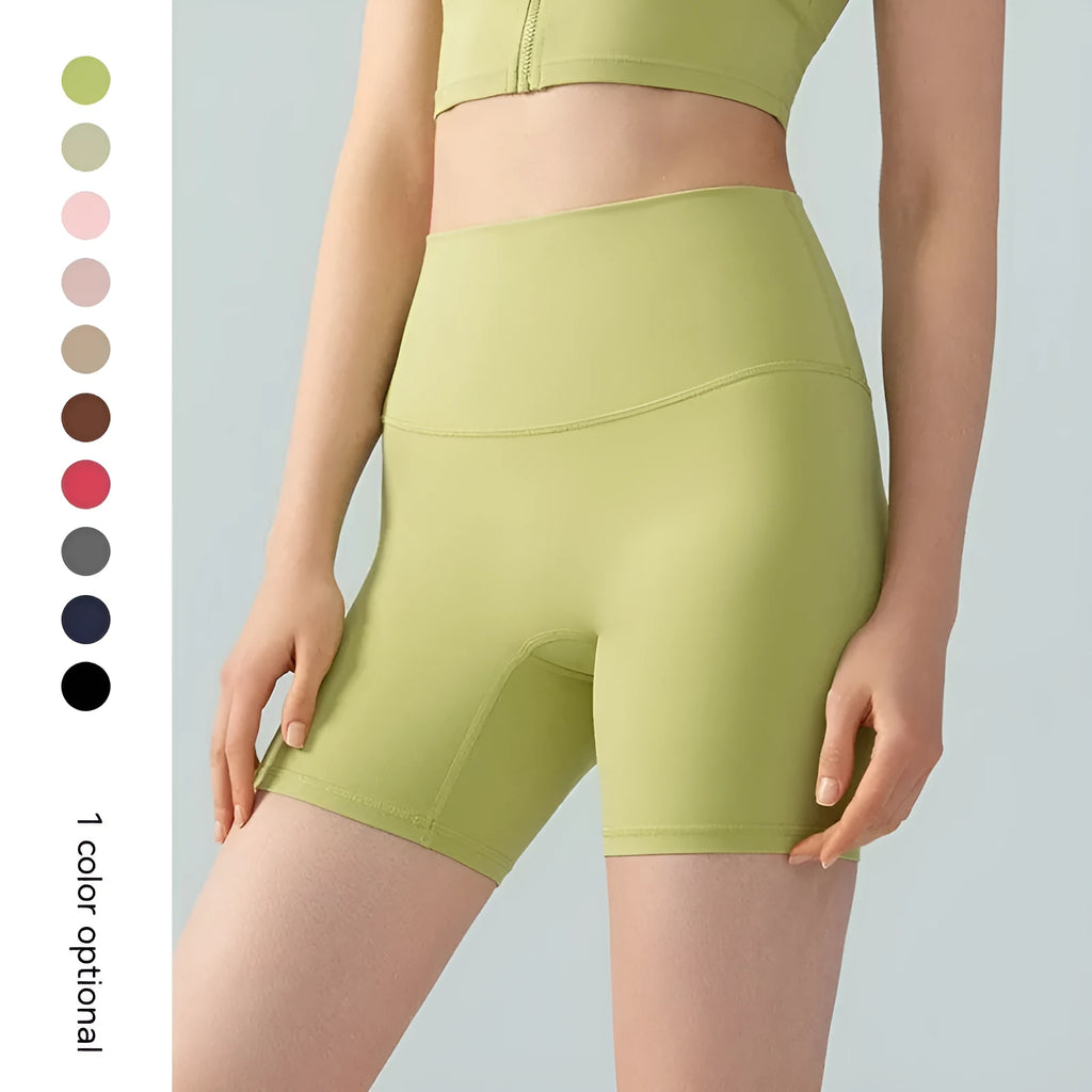 Woman wearing leaf green high waist Lycra yoga shorts for fitness exercise.