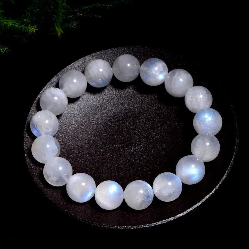 Natural blue moonstone round beads strung on a white cord bracelet.