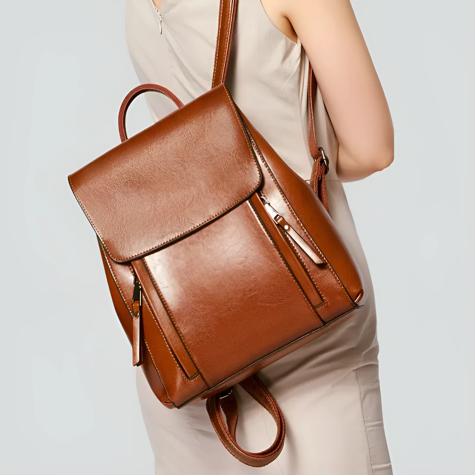 Large black genuine leather women's backpack with multiple pockets and dual straps.