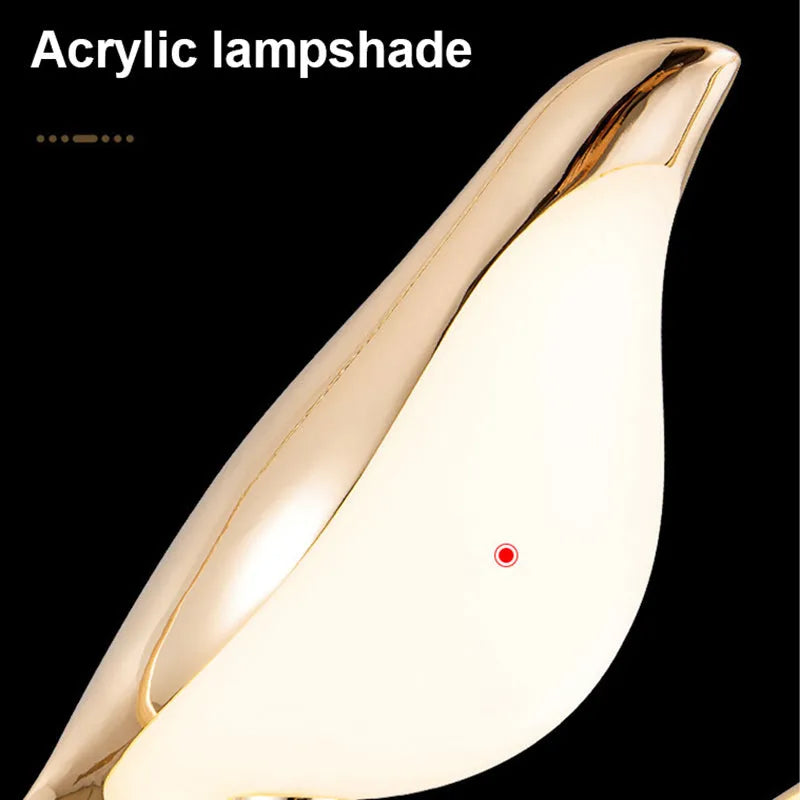 Minimalist clear acrylic magpie bird chandelier ceiling light with a metallic frame.