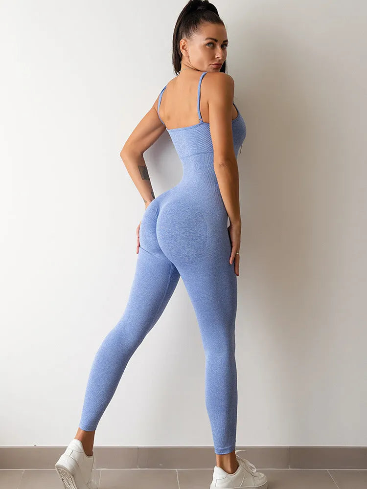 Woman wearing a black sleeveless unitard jumpsuit with spaghetti straps and a backless design.