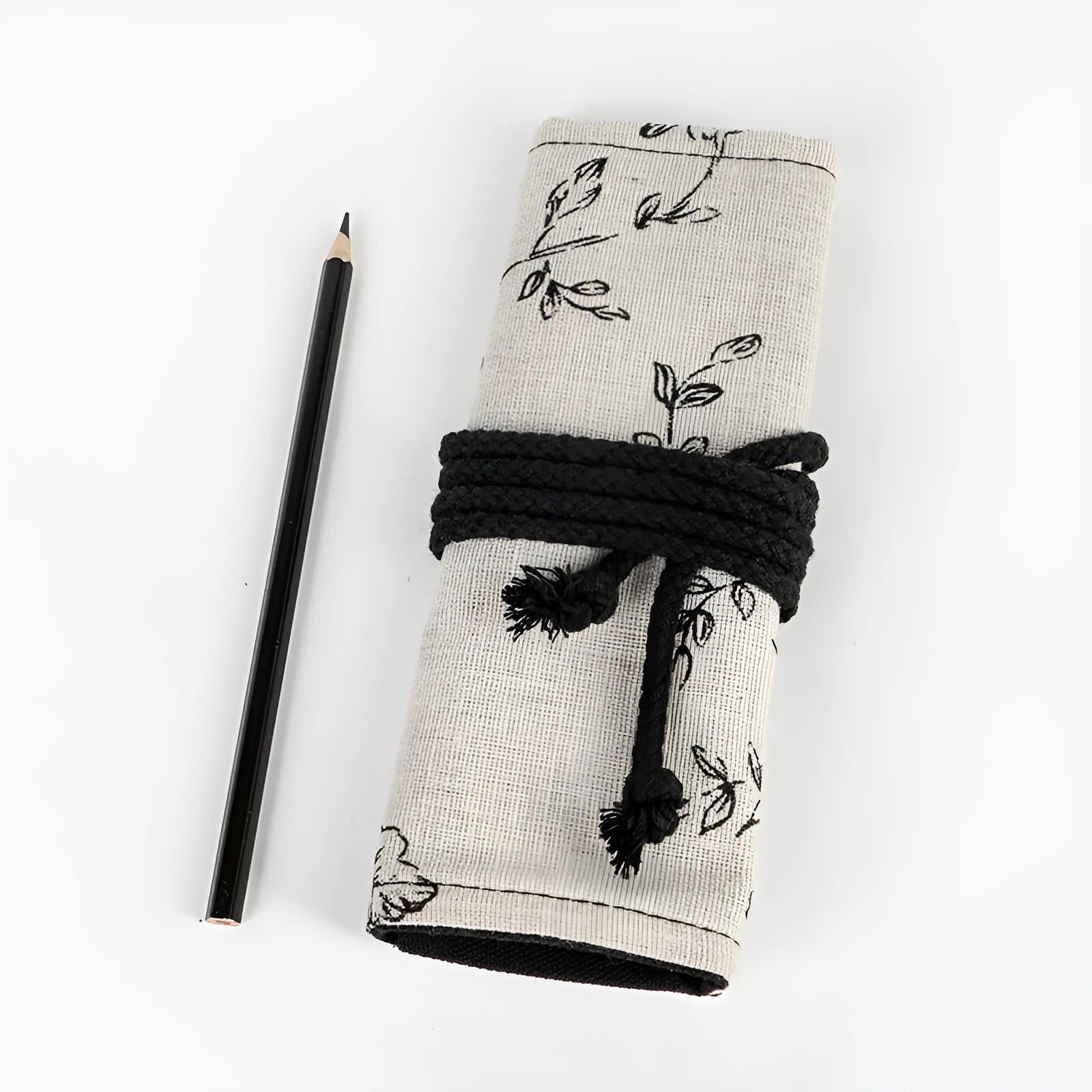 Black peony floral print canvas pencil roll bag open to show multiple tool holes.