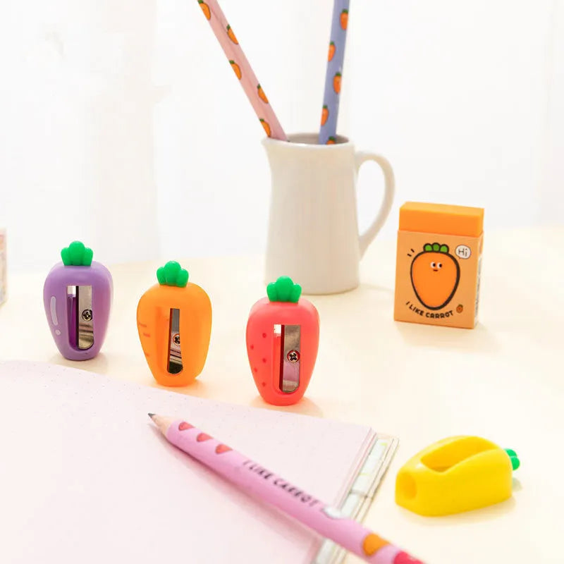 Four fruit and vegetable shaped mini pencil sharpeners in random colours on a light surface