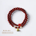 Hand-woven double circle bracelet with purple gold cinnabar beads and lotus design