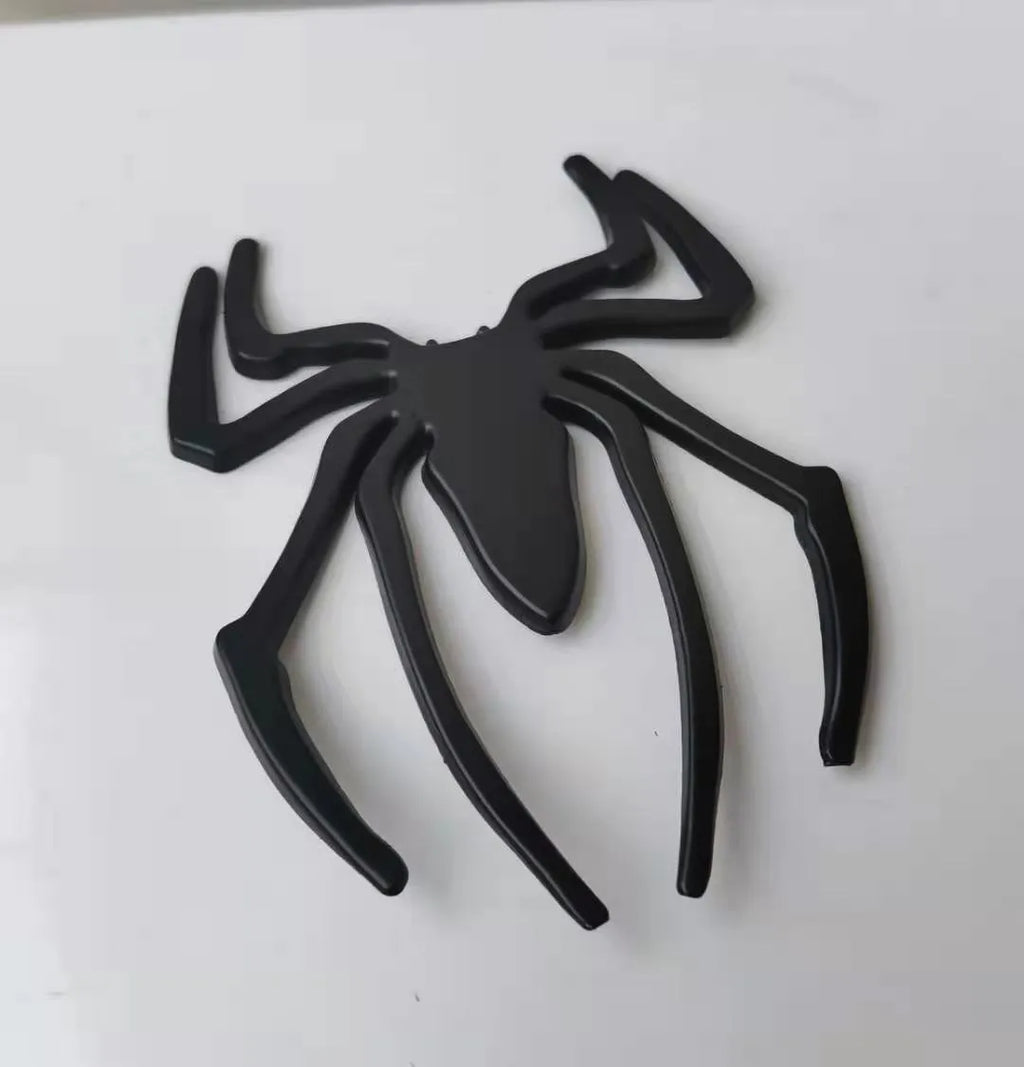 Three-dimensional metal spider car sticker in zinc alloy on a vehicle bumper.