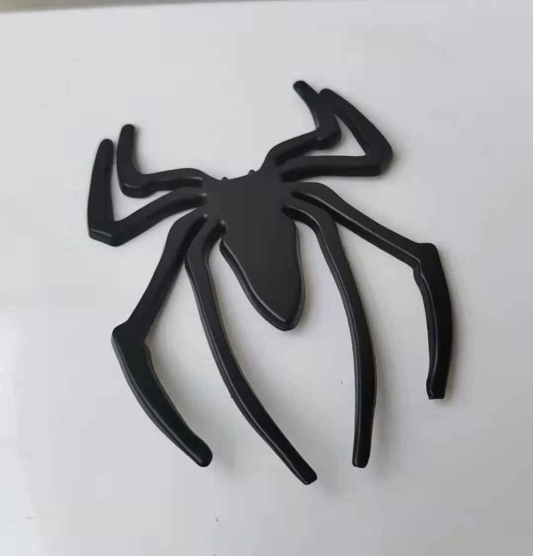Three-dimensional metal spider car sticker in zinc alloy on a vehicle bumper.