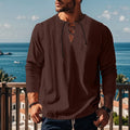 A man's solid colour cotton linen beach shirt in a loose pullover style, shown in army green.
