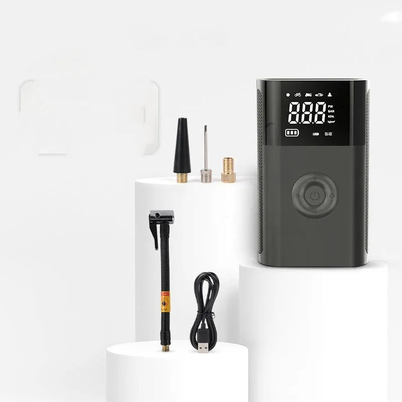 Black handheld digital car tyre pump with LED display and attached air hose, alongside bicycle and ball nozzles.