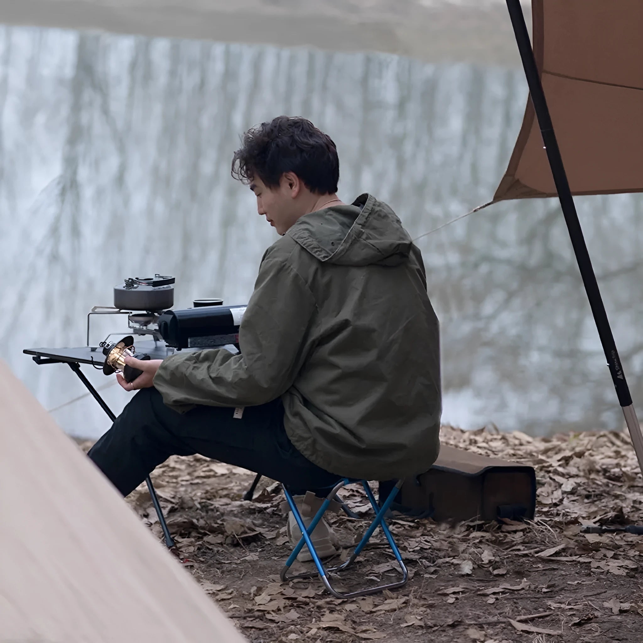 Black national style aluminium alloy folding camp stool shown in open and folded positions.