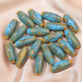 Ceramic bullet beads in various colours for jewellery making and craft projects