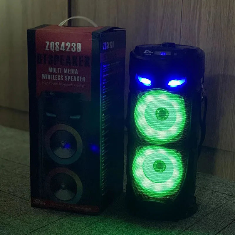 Black portable Bluetooth speaker with dual horn design and MP3 card slot on desktop
