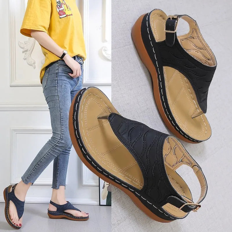 Women's red wedge heel sandals with an adjustable back strap buckle.