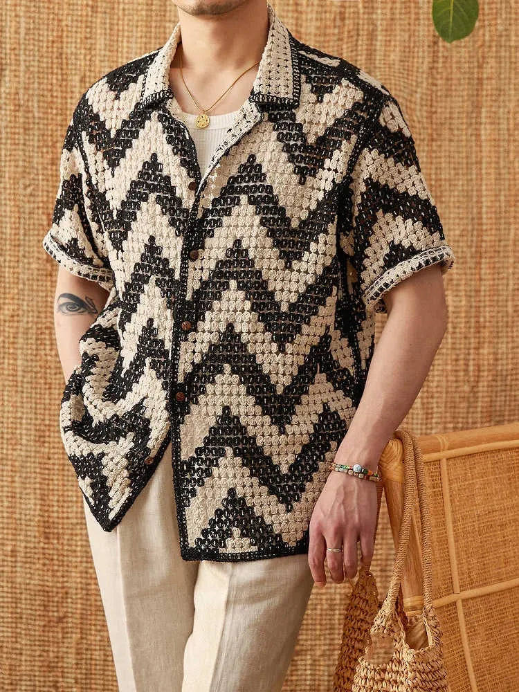 Beach knitted short-sleeved cardigan in black with lapel collar and loose fit on a woman