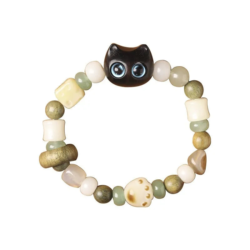 Hand-woven bracelet with bodhi seeds, jade, and wood featuring cartoon cat charm in multiple colour options