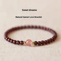 Women's garnet bracelet with U-shaped design showing polished stones in garnet colour