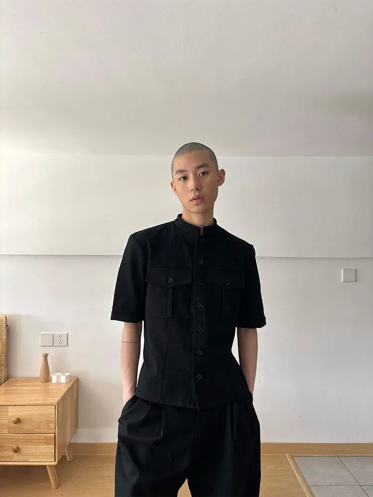 Handmade black half-sleeve shirt with a shirt collar and single-breasted front, shown in a loose fit.