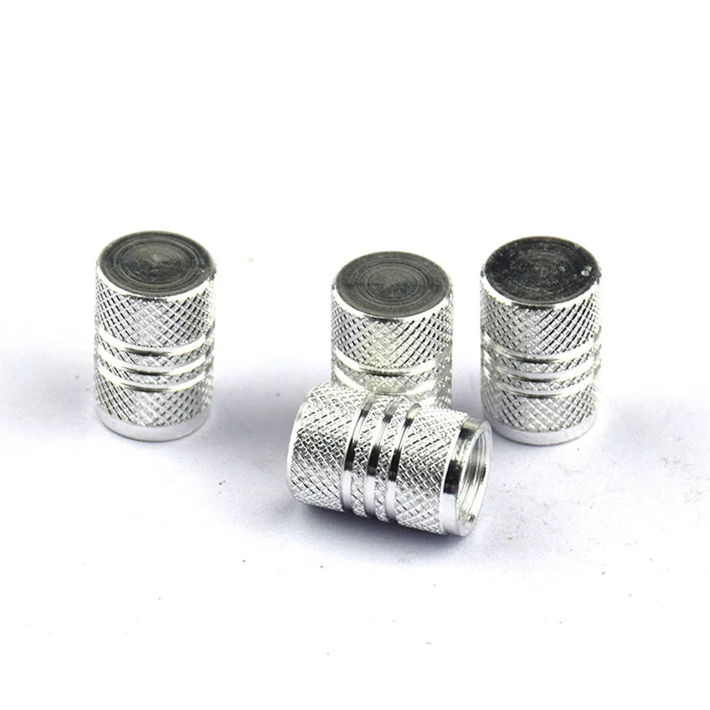 Set of stainless steel car tyre valve caps in multiple colours including red, blue, black, and silver.