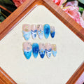 Blue hand-painted carved fake nails set with floral designs in sizes XS S M L