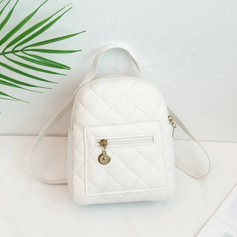 Girls' hard-case embroidered backpack in pink, showing front design and shoulder straps.