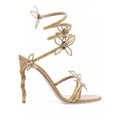 Snake butterfly rhinestone flower stiletto heel Roman sandals in gold with round toe and buckle closure