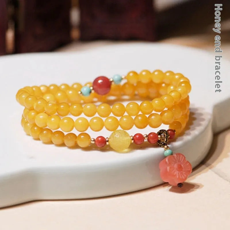 Women's retro-style amber bracelet with animal zodiac modelling in yellow chicken grease colour, 5mm round beads.