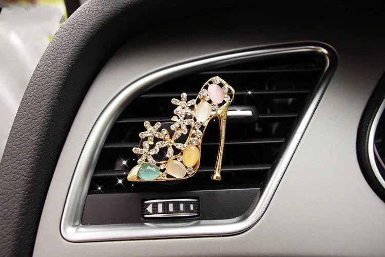 Alloy car fragrance clip with decorative charm attached to car air vent